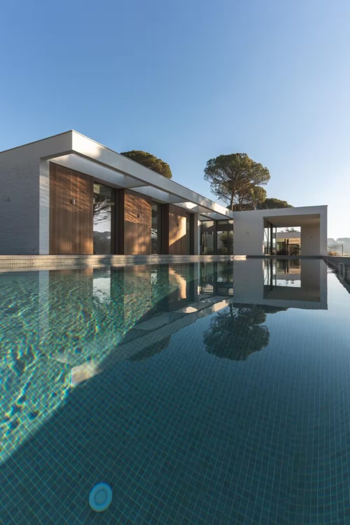 Modern house with pool and minimalist design—contemporary residential architecture emphasizing clean lines, natural light, and luxury living.