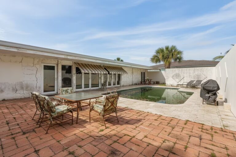 Old house with a deteriorated swimming pool—pre-renovation scene documenting an architectural restoration and value-add project.