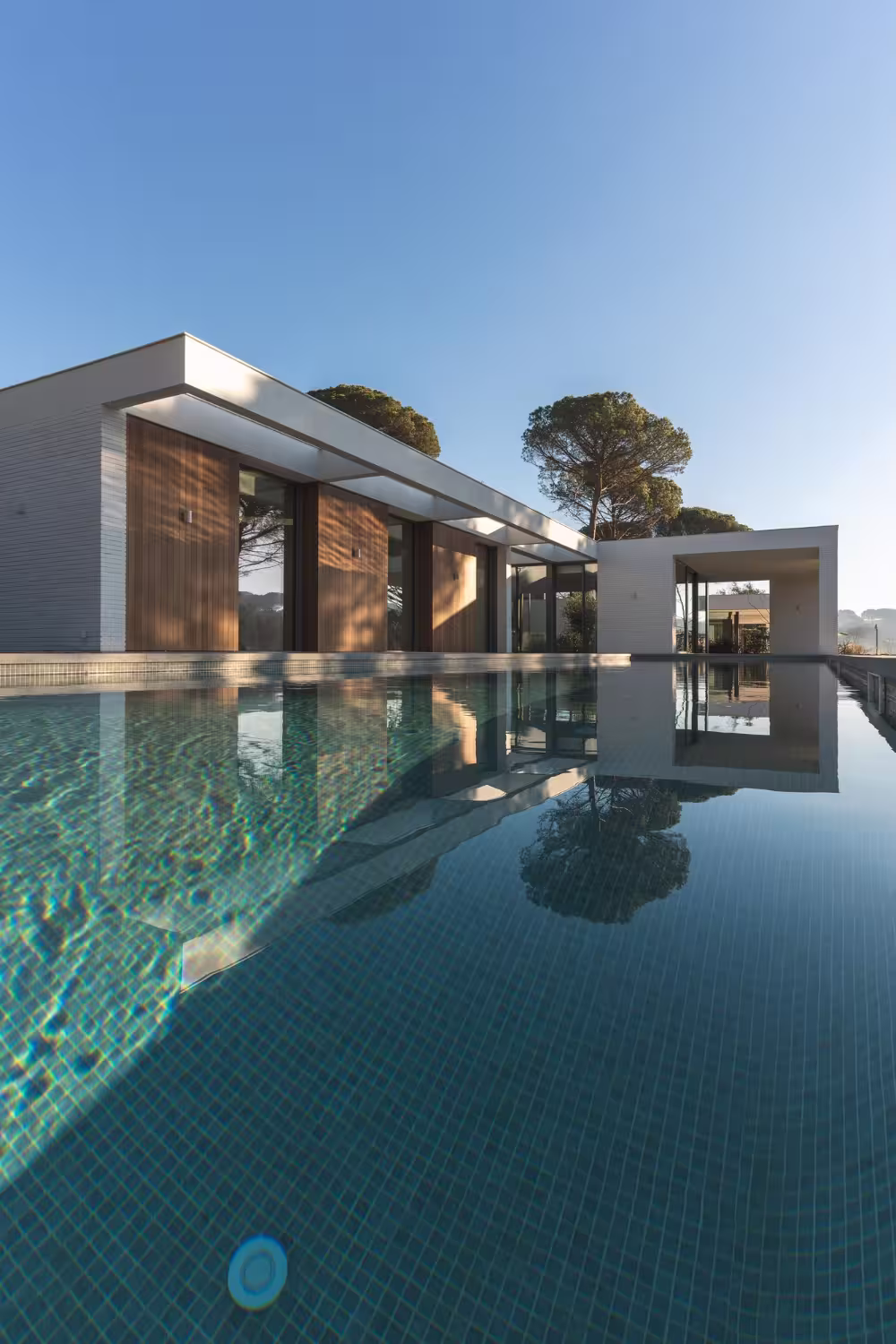 Modern house with pool and minimalist design—contemporary residential architecture emphasizing clean lines, natural light, and luxury living.