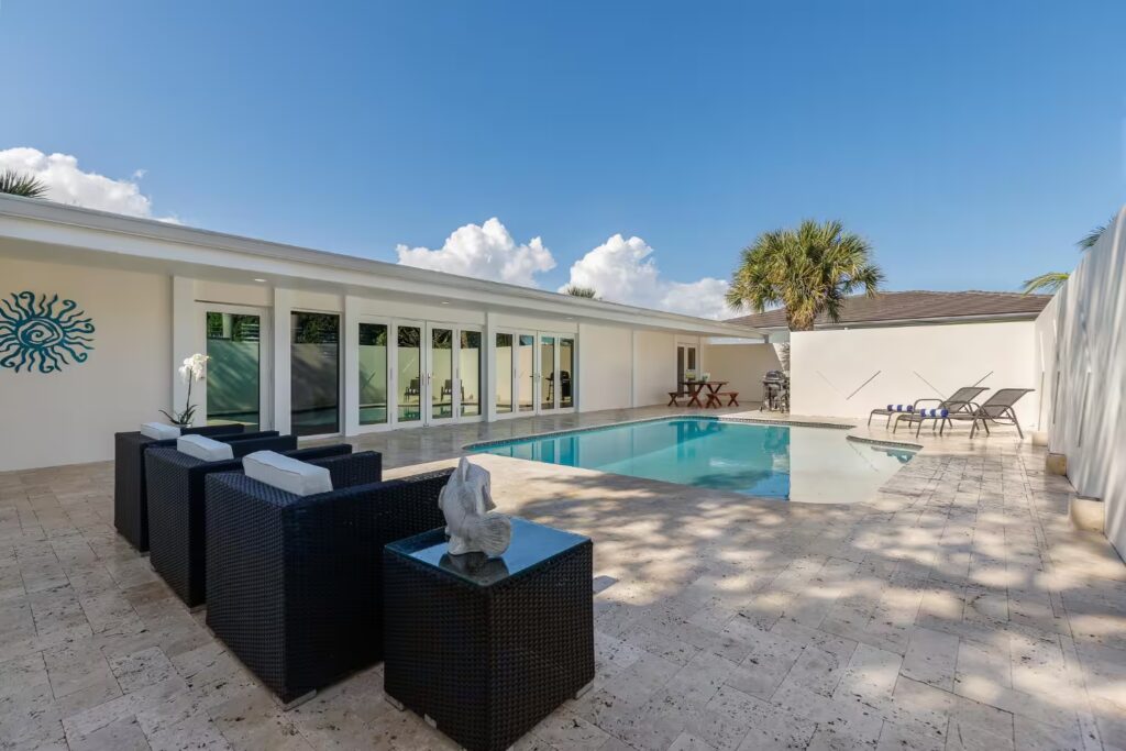 Modern outdoor patio with pool and tropical design — ARCSA Capital