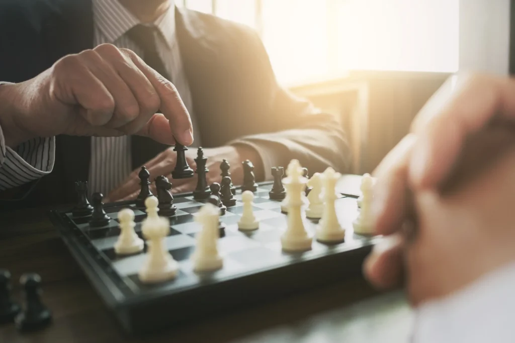 Businessman planning over a chessboard—symbolizing ARCSA CAPITAL’s strategic, institutional real estate investment approach in Miami.