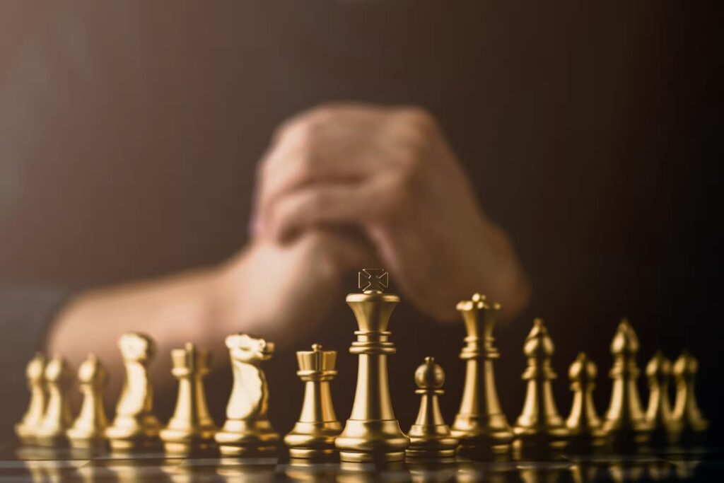 Golden chess pieces on a chessboard—symbol of strategic planning, foresight, and disciplined corporate decision-making.