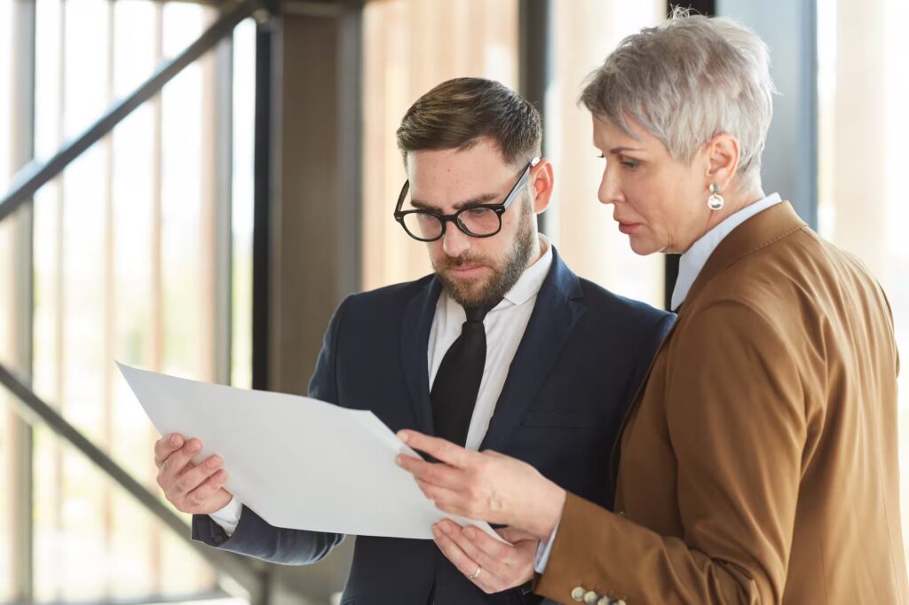 Business consultants reviewing documents together in professional office environment