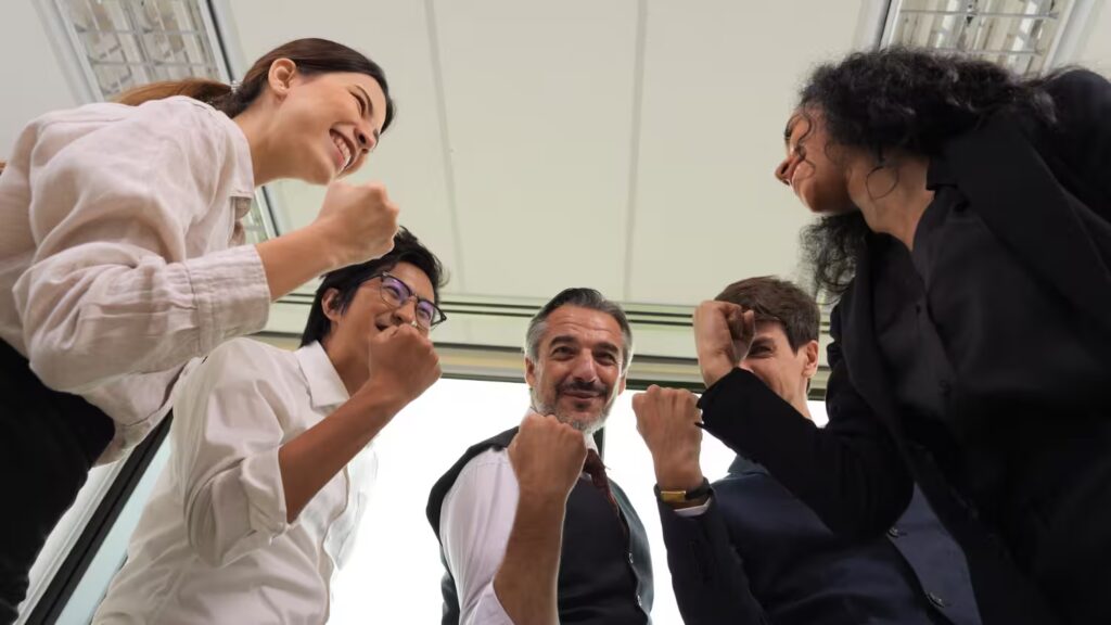 Diverse team celebrating success in modern office