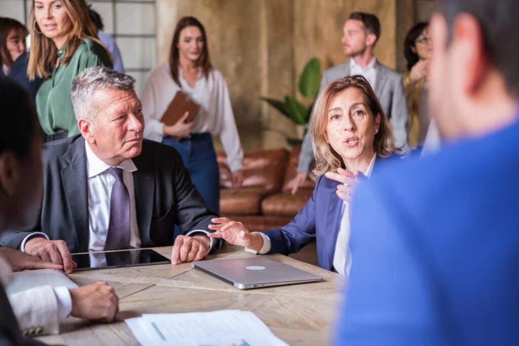 Financial advisor discussing due diligence with high-net-worth female clients.