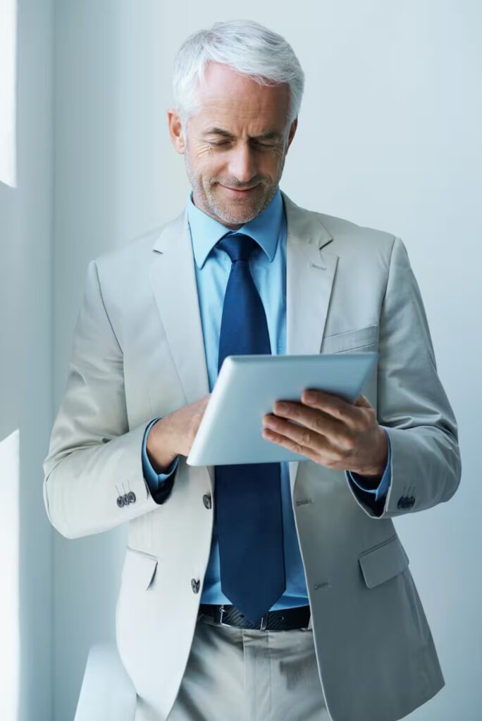 Executive reviewing his secured retirement portfolio on a digital tablet.