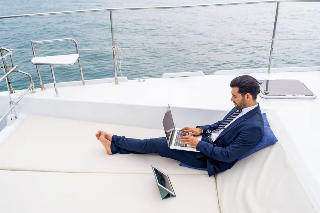 Successful investor managing returns and working remotely from a luxury yacht.