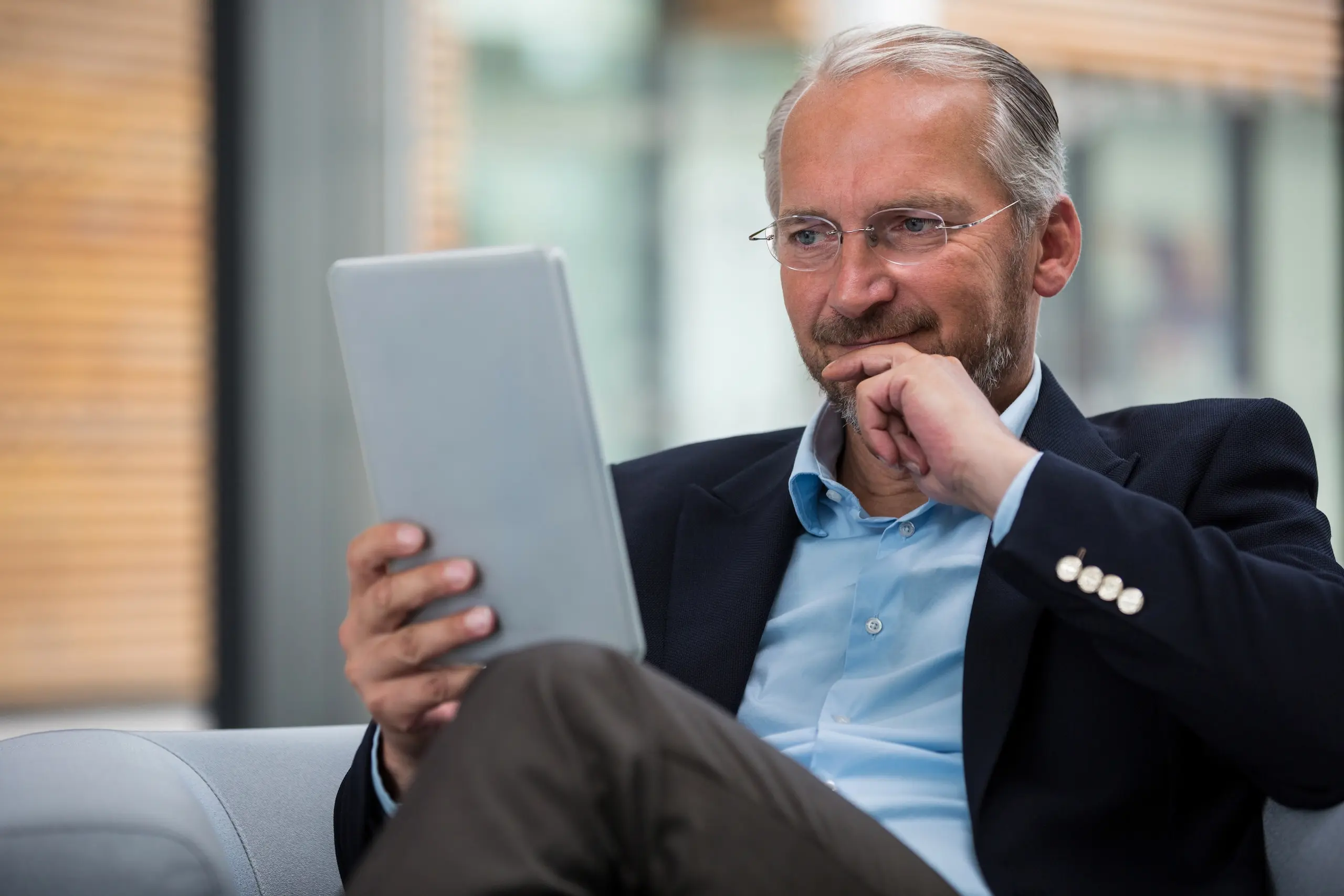 Accredited investor comparing REITs and multifamily syndication on an iPad, analyzing why ARCSA Capital’s institutional real estate strategy is different